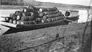 Wooden barrels for the International Bitumen Company loaded on a barge, ca. 1936<br/>Source: Provincial Archives of Alberta, A3386
