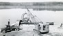 Oil Sands Ltd. crane unloading a barge at Bitumount, ca. 1947<br/>Source: Provincial Archives of Alberta, PR1968.0015.27-19