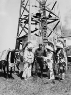 Stoney people receive payment for oil leases near Morley, Alberta, 1929. When oil and gas was discovered on the Stoney reserve, oil companies paid for access rights to drill on the reserve. Each reserve resident received $10/year and a share of royalties. Community investment and environmental protection, however, were not considered. To address such deficiencies, the Indian Minerals Unit was established to manage oil and gas leases and resource development on reserves.