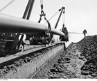 A section of the Interprovincial Pipeline being laid near Regina, Saskatchewan, 1954.