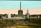 Separators in the foreground; two actifiers flanking an H2S stack, with an absorption building behind, ca. 1926; a second set of absorbers, actifiers and stack were built shortly after. <br />Source: McCord Musuem, MP-0000.25.582