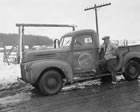 A Royalite truck and employee, ca. 1941; Royalite maintained its own fleet of vehicles to meet the needs of its plant and drilling operations. <br />Source: Glenbow Archives, IP-14a-857