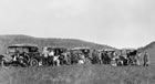 Caravan of automobiles on the road to Turner Valley, 1914; with the coming in of the Dingman No. 1 well on May 14, 1914, Calgary went "oil crazy." Investors and sightseers went out to Turner Valley to see the wonder for themselves. <br />Source: Glenbow Archives, NA-217-75