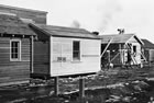 This small house is typical of the mass-produced, mobile dwellings that were common in the Turner Valley area, 1938. <br />Source: Glenbow Archives, NA-2895-14