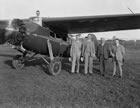 A group in Edmonton poses in front of an airplane preparing to leave for Turner Valley, Alberta, 1929. Aviation made it possible for managers, geologists and others to easily access remote resources and plant sites. <br />Source: Glenbow Archives, ND-3-4871b