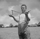 A British farmer hopes a dowsing rod will lead him to water. A dowser will hold an end of a fork-shaped branch in each hand and walk slowly around the target area. When the rod or branch twitches or dips, the dowser has located his goal. Dowsing has been used in the quest not just for petroleum, but also for metals, gemstones, gravesites, tunnels, and weapons. Alas, numerous studies and experiments have yet to prove that it is a reliable method. Source: Imperial War Museum, D9817