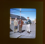 Karl Clark (left) and Lloyd Champion (centre) stand on the wooden sidewalk outside the cook house, late 1940s<br/>Source: University of Alberta Archives, 83-160-03