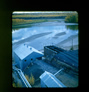 Ramp leading to the truck dump above the oil sands hopper, built up from oil sands and reinforced on the sides with log cribbing, late 1940s<br/>Source: University of Alberta Archives, 83-160-2