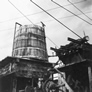 A water tower at the uphill end of the International Bitumen Company separation plant fed heated water into the oil sands hopper, n.d.<br/>Source: University of Alberta Archives, 83-160-97