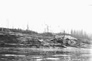 Separation plant at the International Bitumen Company site, ca. 1931; the huge pile of wood was fuel for the boiler that ran the separation plant.<br/>Source: University of Alberta Archives, Comfort – 84-25 – 82.1.242