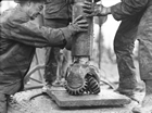 A rotary drill bit being prepared for lowering into the well. Source: Provincial Archives of Alberta, P6896