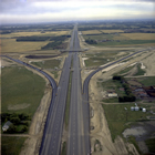Highway 2 under construction, 1975; oil revenues allowed the construction of impressive highways, reaching across Alberta to join major centres as well as more remote and smaller, rural communities.