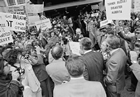 Prime Minster Trudeau makes his way through a protest to enter the Palliser Hotel, June 1974. Note: Reporter (and future Premier of Alberta) Ralph Klein stands with the microphone to Trudeau’s left.