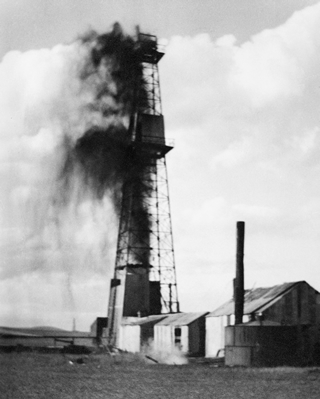 Oil well Royalties No. 1 as a gusher after striking oil on June 16, 1936. Source: Glenbow Archives, NA-2335-2
