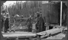 Karl Clark (centre) observing the output of the Clearwater River oil sands separation plant, 1930<br/>Source: University of Alberta Archives, 69-160-A1-0001-detail