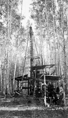 Drilling, powered by a Fordson tractor, near Fort McMurray by Sidney Ells, 1925. Source: Library and Archives Canada, PA-138536