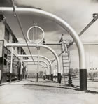 Overhead and underground pipes move gases and liquids around the Turner Valley gas plant, ca. 1946-1947. <br />Source: Glenbow Archives, IP-14a-2595