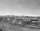 The Turner Valley plant, looking northwest from the Sheep River, ca. 1942; at the outbreak of the Second World War, the plant was a state-of-the-art facility and would rise in significance as a petroleum producer and a contributor to Canada’s war effort. <br />Source: Glenbow Archives, IP-14a-763