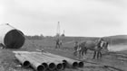 A large storage tank is installed near the Dingman No. 2 well, ca. 1914-1917. Storage tanks were amongst the first equipment to be installed at the Turner Valley site. <br />Source: Glenbow Archives, NA-5262-45