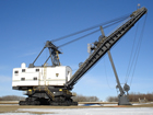 Nicknamed "Mr. Diplomat," the Marion 360 Stripping Shovel on display at the Diplomat Mine Museum near Forestburg, Alberta, bears significant dimensions: weight: 500 tonnes (551 tons); height to top of boom: 24 m (79 ft.); boom length: 27.5 m (90 ft.); dipper handle length: 17.1 m (56 ft.); dumping radius maximum: 30 m (98 ft.); dipper capacity: 7 cu m (247 cu. ft.).