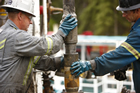 Changing a drill bit, Kakwa, Alberta; in the Grand Cache area of west central Alberta, Encana Corporation extracts natural gas from deep basin tight gas formations using the latest technology in horizontal drilling and multi-zone hydraulic fracturing. Source: Courtesy of Encana Corporation