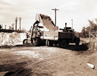 Handling sulfur at Madison natural gas facility, Turner Valley, 1952; after the molten sulfur cooled into a solid, it was bagged or loaded onto trucks for transport to the railway at Okotoks. Source: Provincial Archives of Alberta, P2973