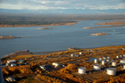 Aerial view of Norman Wells, Northwest Territories, September 2011. The large oil reserves around this small service community are accessed by drilling rigs throughout the territory, including some built on man-made islands in the Mackenzie River. The crude oil from these wells is sent by pipeline to northwestern Alberta and throughout the larger pipeline network from there.