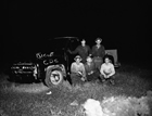 A Home Oil Company well near Erskine (between Red Deer and Stettler) blew out of control in October 1955. This photograph from the October 27, 1955, edition of <em>The Albertan</em> newspaper shows a rig crew standing by a truck. The workers could write slogans in the thick oil covering the vehicle.