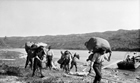 Men carrying sacks of bituminous sands as shipment passes Cascade Rapids on the Athabasca River, 1923; Sidney Ells’s photograph reveals a glimpse of the brutal, back-breaking endeavor necessary to bring out the oil sands before the arrival of the railway in 1925. At the end of his initial exploratory trip, twenty-three days of 24-hour-a-day effort were required by Ells and his crew to haul the scow and loaded barges up the river to Athabasca Landing. Source: S.C. Ells/Library and Archives Canada, PA-137873