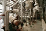 This interior of the fractionation plant , ca. 2010, shows the  large horizontal vessels, at left and centre, that are reboilers for the depropanizer and debutanizer towers, respectively. <br />Source: Alberta Culture and Tourism