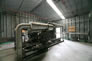 This interior view of the propane compressor building, ca. 2010, shows the White Superior compressor. <br />Source: Alberta Culture and Tourism