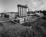 Turner Valley gas plant absorption plant with its four absorber towers and one slightly taller reabsorber tower, ca. 2010; the propane plant and gasoline plant are to the right and the fractionation plant is to the left. <br/>Source: Alberta Culture and Tourism
