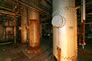 Components of the Merox plant inside the gasoline plant, ca. 2010. From left: Merox mix tower, oxidizer tower and extractor tower <br/>Source: Alberta Culture and Tourism
