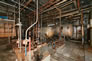 Interior of the gasoline plant, showing the Merox plant equipment, ca. 2010. The Merox plant used a process that became available in 1958. It was a new way of sweetening gas and removing sulfur by using a caustic solution in a closed system. <br/>Source: Alberta Culture and Tourism