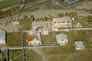 This aerial view includes, from the left, the light plant (rusty-roofed structure), the machine shop and the welding shop, at right. Behind is the sulfur plant. <br/>Source: Alberta Culture and Tourism, AB070914295