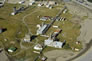 This aerial photo of the Turner Valley Gas Plant Historic Site shows the oil/water separator building in the foreground. It is the small square structure on the lower terrace. <br/>Source: Alberta Culture and Tourism, AB070914309