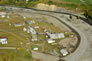 This aerial view shows the three absorption oil tanks at left, next to the cold water storage tank. Absorption oil was part of a closed system running through the absorption and gasoline plants, located directly to the right. The tanks held new supplies of absorption oil. <br />Source: Alberta Culture and Tourism, AB070914327