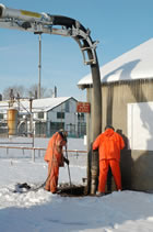 A crew clears an office and laboratory building foundation with hydro excavation machinery, 2012. <br />Source: Alberta Culture and Tourism