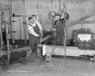 Dressing a cable tool drill bit; the bit was heated in a forge and then reshaped to restore its cutting edges, n.d. <br />Source: Provincial Archives of Alberta, P1929