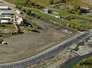 The water treatment plant, at right, located just above the berm, purifies groundwater from the Turner Valley Gas Plant Historic Site before releasing it into the Sheep River, ca. 2007. <br />Source: Alberta Culture and Tourism