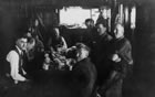 A work crew eats lunch in a boiler house, 1940. <br />Source: Glenbow Archives, NA-2335-12