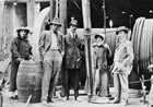 A group poses with the drill bit at Dingman No.1, Turner Valley, May 24, 1914. Samuel G. Coultis stands at centre. <br />Source: Glenbow Archives, NA-4766-1