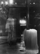 Emptying the bailer after pulling it from the well, Turner Valley, 1914 <br />Source: Glenbow Archives, NA-952-11