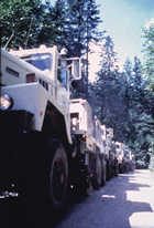 Scientists use sound waves created by vibration and explosion to produce images of structures as much as 50 km (31 mi.) below the Earth’s surface. These 10-ton trucks bounce up and down on the ground in a carefully choreographed "dance." The reflection of the resulting sound waves is recorded by sensitive microphones, called geophones. Source: Reproduced with the permission of Natural Resources Canada 2013, courtesy of the Geological Survey of Canada, F92S0113