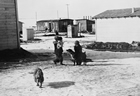 Street in Little Chicago (Royalties), Turner Valley, 1938; by 1938, a thousand people lived in 360 homes and shacks in Little Chicago where they could patronize cafes, restaurants, a theatre, an ice rink, a drug store, lumber yards and other businesses. Source: Glenbow Archives, NA-2895-11