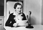 Miss Elsie Currie, home service director, Canadian Western Natural Gas Company, Calgary, Alberta, ca. 1930s; in 1930, one home service department provided the following description of its role: "Our Home Service Department is at your command at any time for consultation and to assist you in solving your household problems. There is no charge for this service. Its sole purpose is to make your important part as home manager…broader…more complete…less laborious and happier – how to obtain maximum efficiency and economy in the operation of your Gas appliances.". Source: Glenbow Archives, NA-1446-27