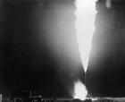 Flaring at Royalite Well No. 4, November 1924; many of the substances emitted by flaring petroleum are produced during other human activities as well, such as by auto emissions, smoking cigarettes and using barbeques. Nonetheless, they are toxic. Even pure methane is a greenhouse gas. Because it is more potent than CO<sub>2</sub>, however, many believe that flaring it is preferable to simply releasing, or venting, it into the atmosphere. Source: Glenbow Archives, NA-2849-178