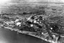Landing area built up on the bank of the Athabasca River just below the Alberta Government Oil Sands Project separation plant (centre), ca. 1950<br/>Source: University of Alberta Archives, 80-143-3