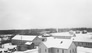 Bunk house in winter (centre), behind cook house and dining hall, Alberta Government Oil Sands Project camp, 1946<br/>Source: University of Alberta Archives, 83-160-107