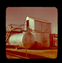 Accumulator tank (left), settler tank (right), and valve control shed (top), Alberta Government Oil Sands Project, 1949<br/>Source: University of Alberta Archives, 91-137-047